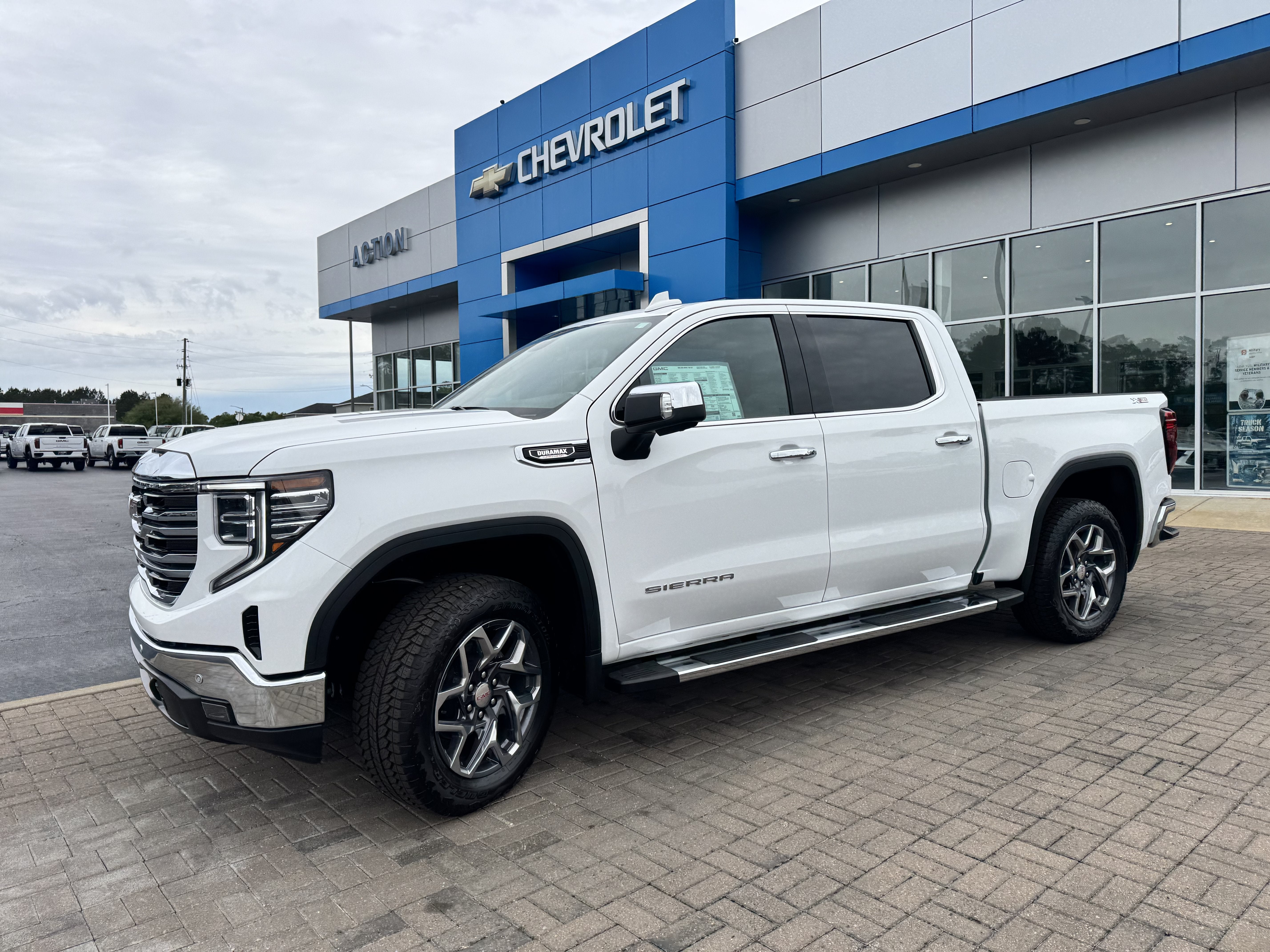 2026 GMC Sierra 1500 SLT in Summit White — front three-quarter view
