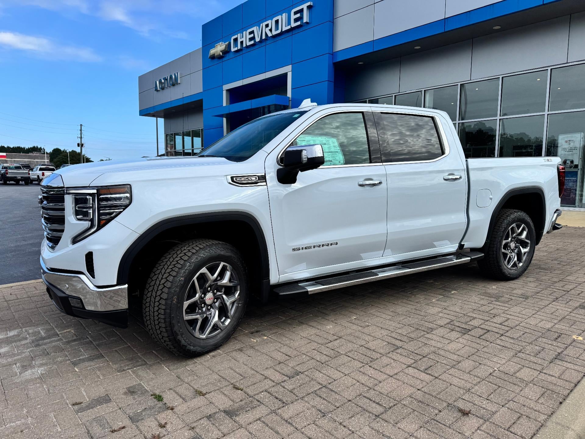 2026 GMC Sierra 1500 SLT in Glacier White Tricoat — front three-quarter view