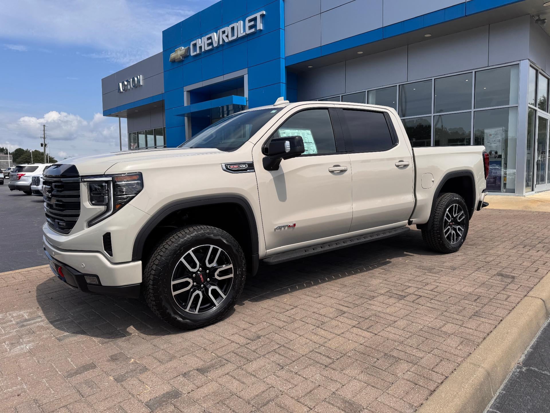 2026 GMC Sierra 1500 AT4 in Coastal Dune — front three-quarter view